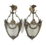 A pair of gilt-metal & frosted glass ceiling light fittings in the rococo style, of ovoid form, &