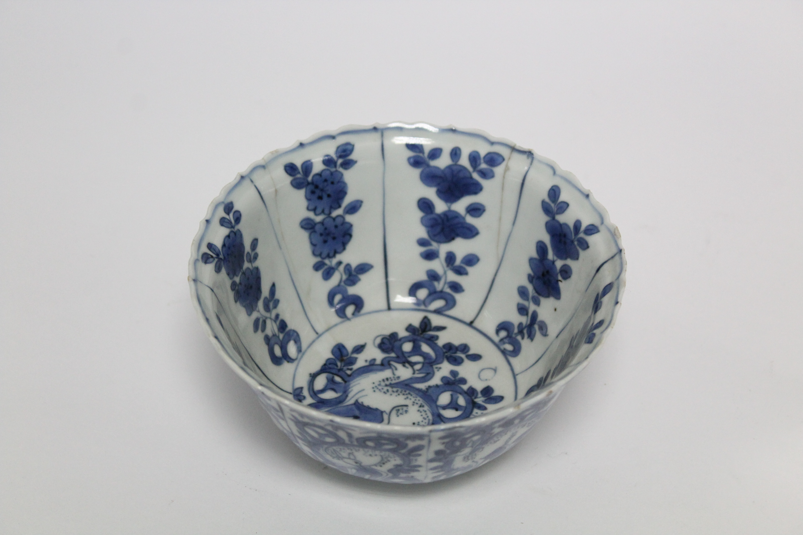 A Chinese blue & white porcelain deep bowl with lotus rim, painted with panels of deer amongst - Image 3 of 24