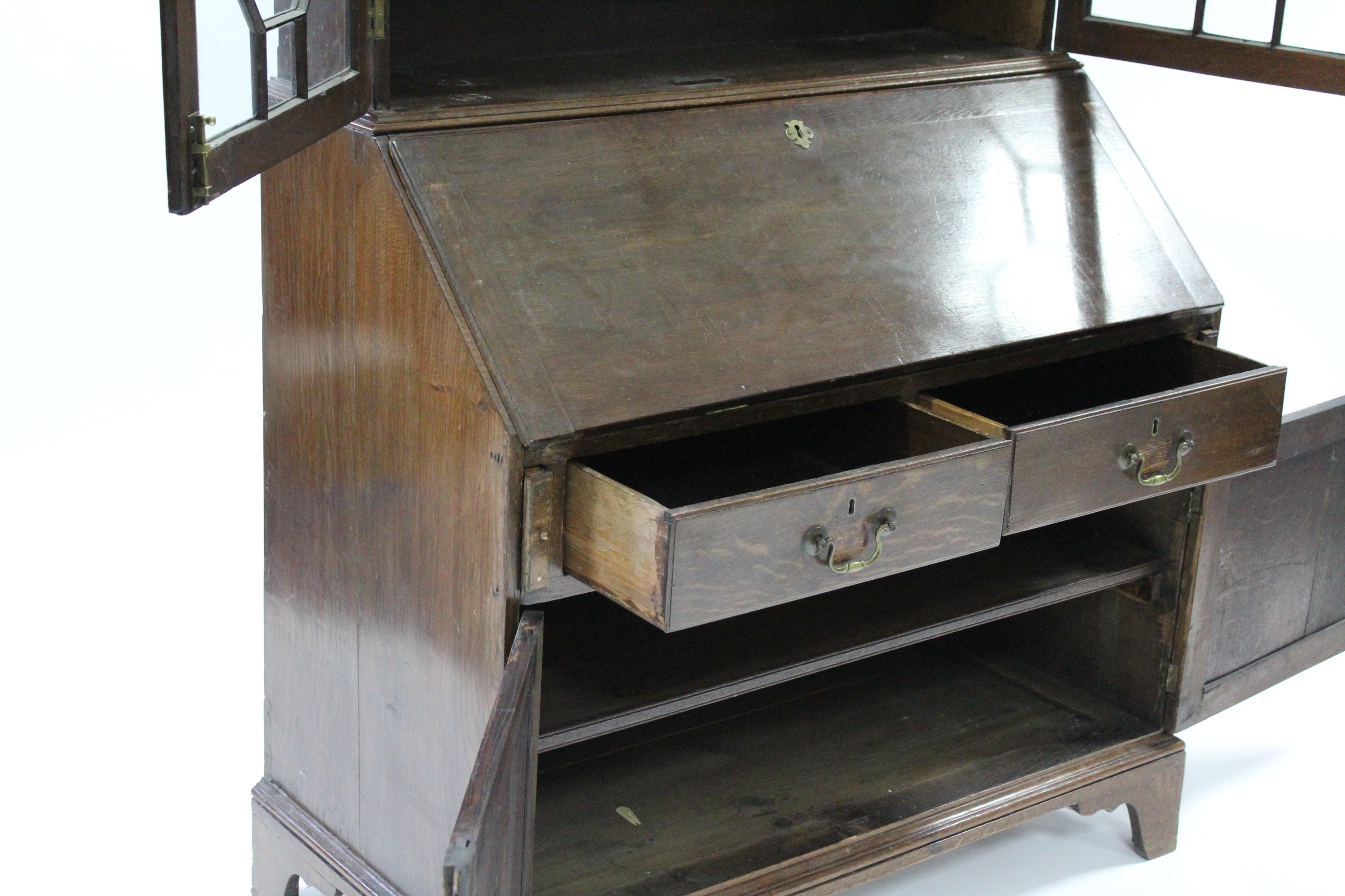 An 18th century oak bureau-bookcase, the upper part fitted three adjustable shelves enclosed by pair - Image 6 of 6