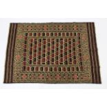 A Kelim rug of crimson & ivory ground with central guhl motif within multiple hook & geometric