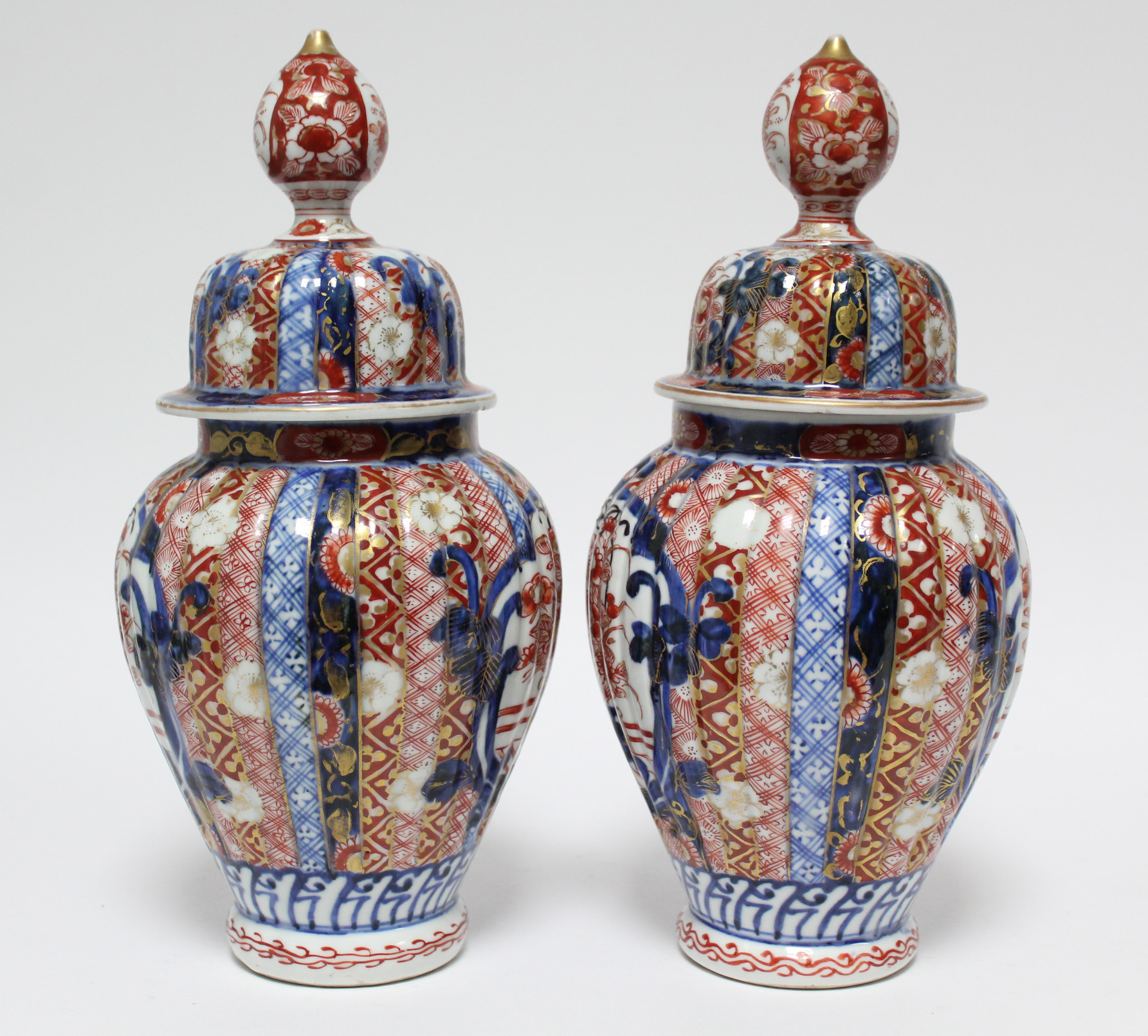 A pair of 19th century Japanese Imari fluted baluster vases with domed covers; 12” high. - Image 4 of 8