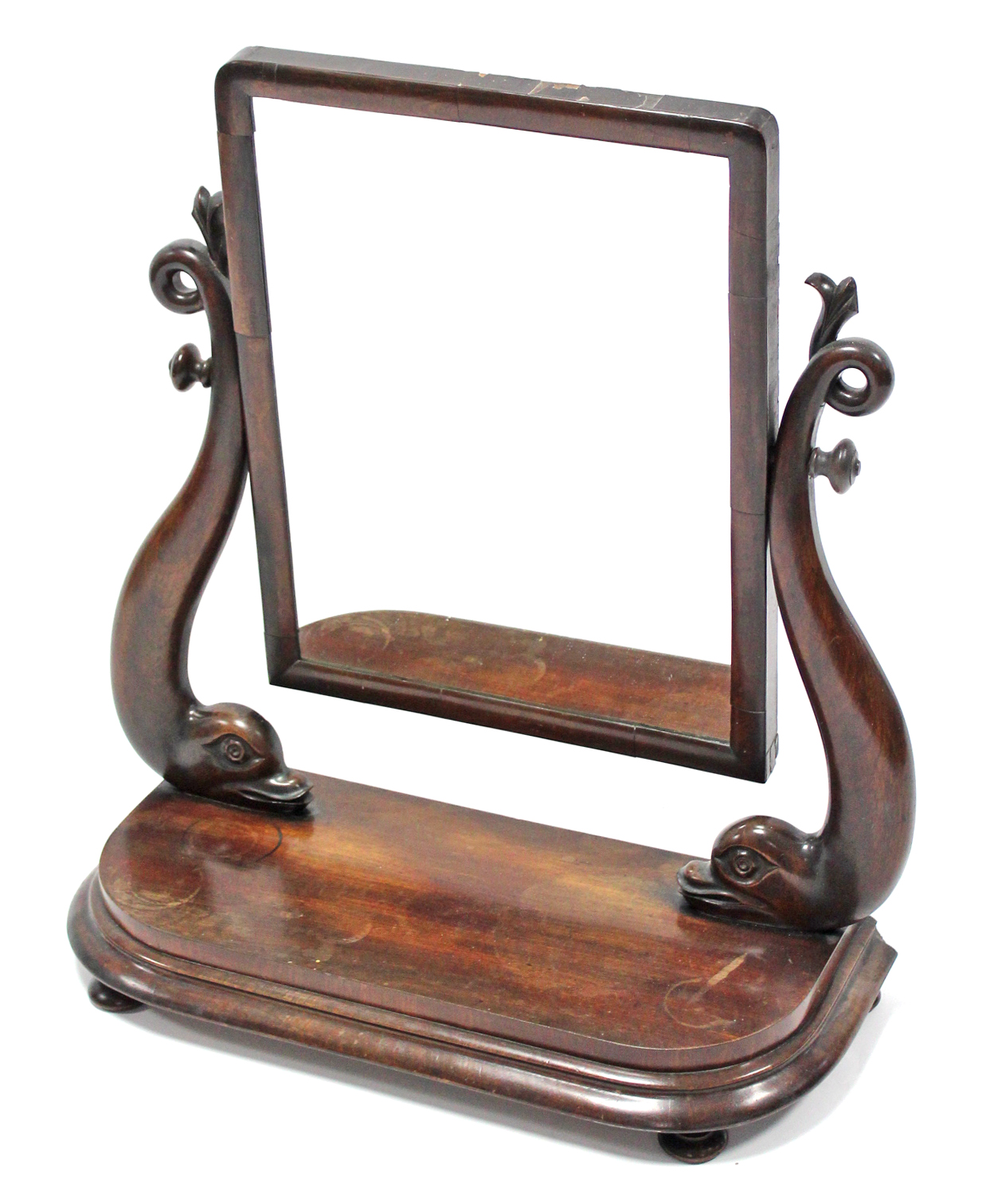 A mid-Victorian mahogany swing toilet mirror, the rectangular plate on carved dolphin supports &