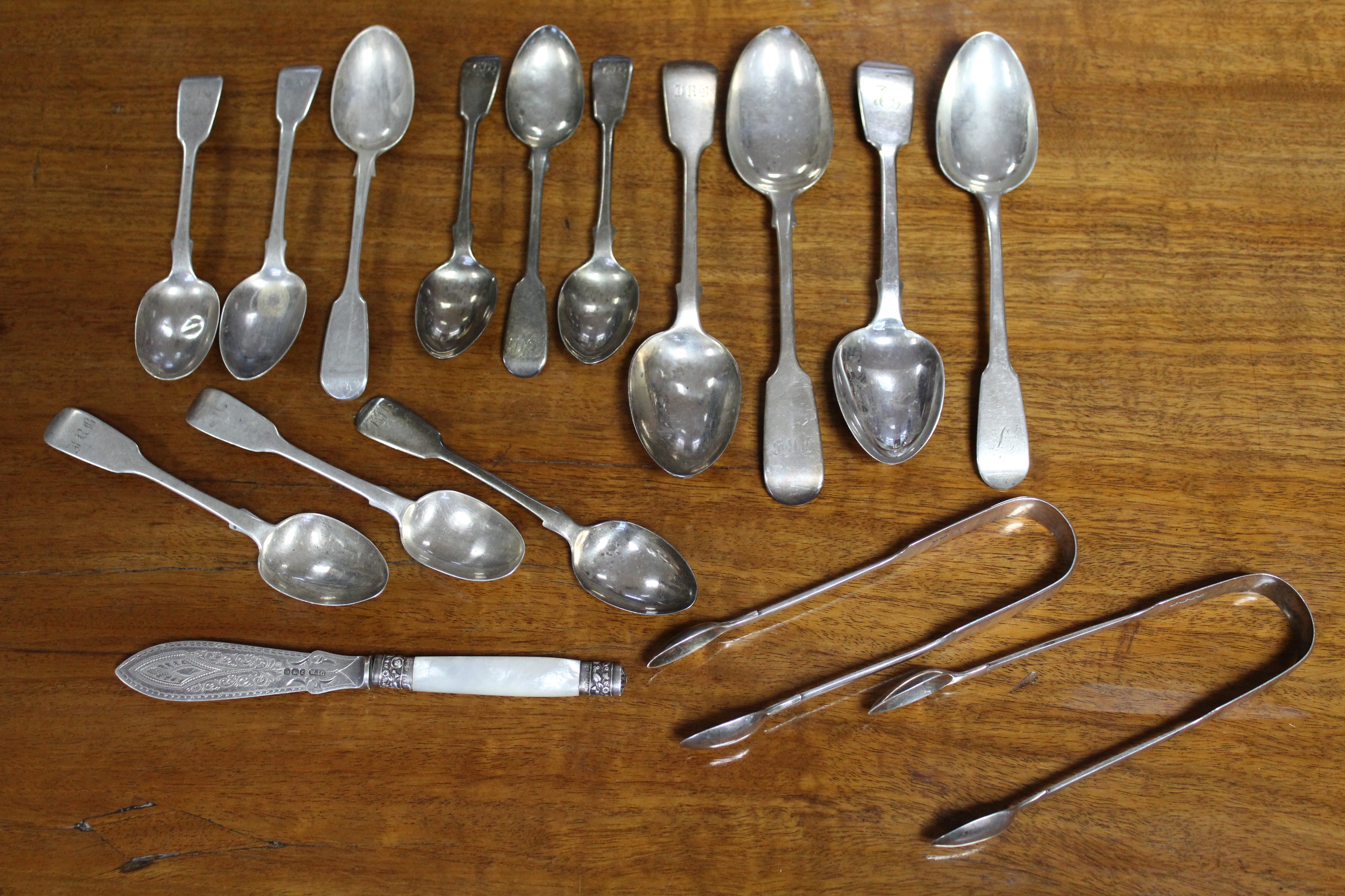 Two pairs of Victorian silver Fiddle pattern sugar tongs; four Georgian & Victorian Fiddle pattern