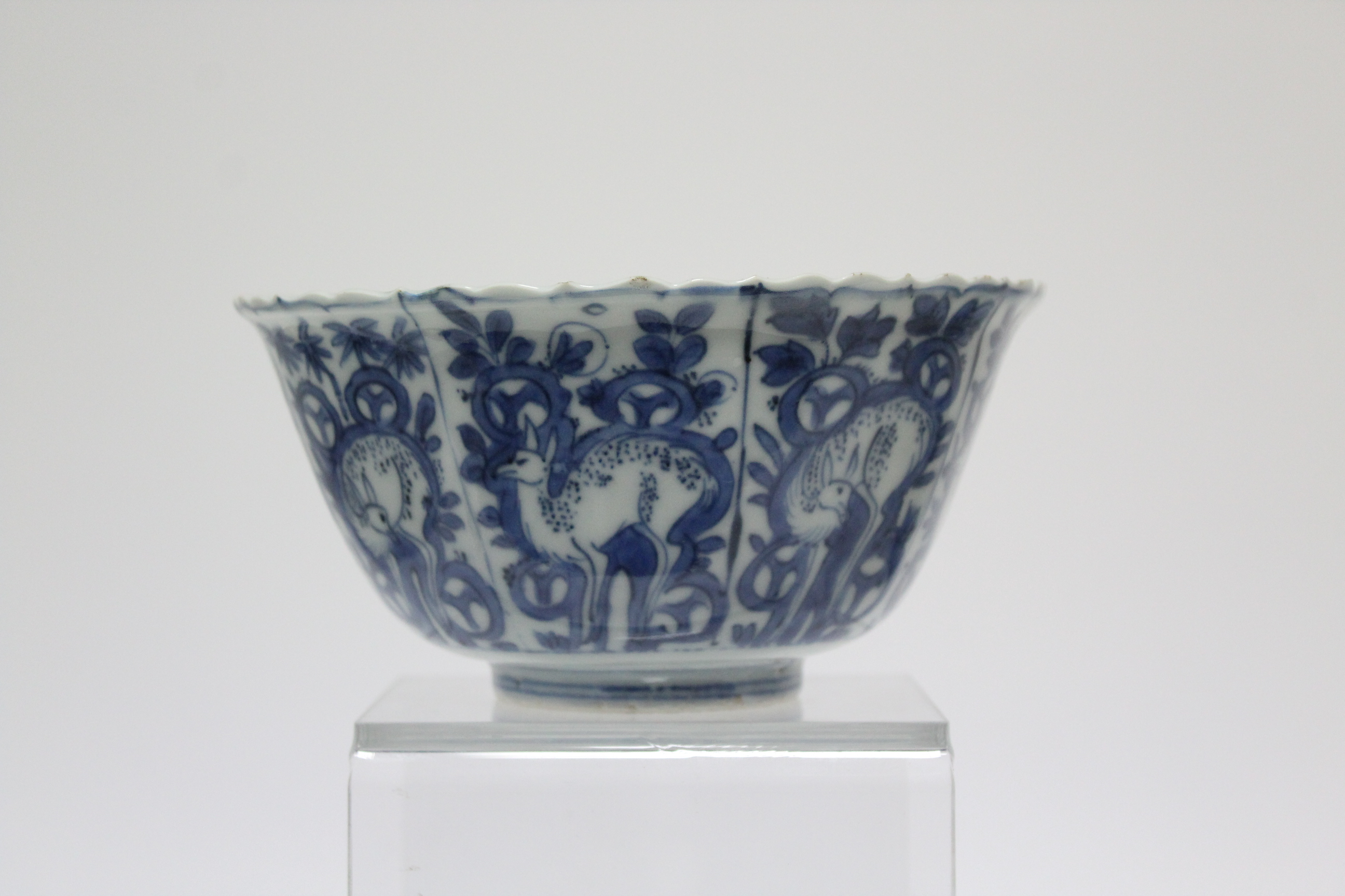 A Chinese blue & white porcelain deep bowl with lotus rim, painted with panels of deer amongst - Image 11 of 24