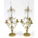 A pair of 19th century gilt-brass three-branch candle lustres, with scroll arms, & hung with cut-
