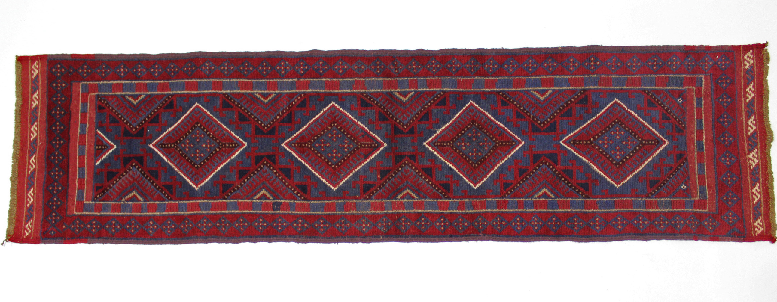 A Meshwari runner of crimson, deep blue, & ivory ground, with single row of four lozenges within