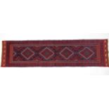 A Meshwari runner of crimson, deep blue, & ivory ground, with single row of four lozenges within