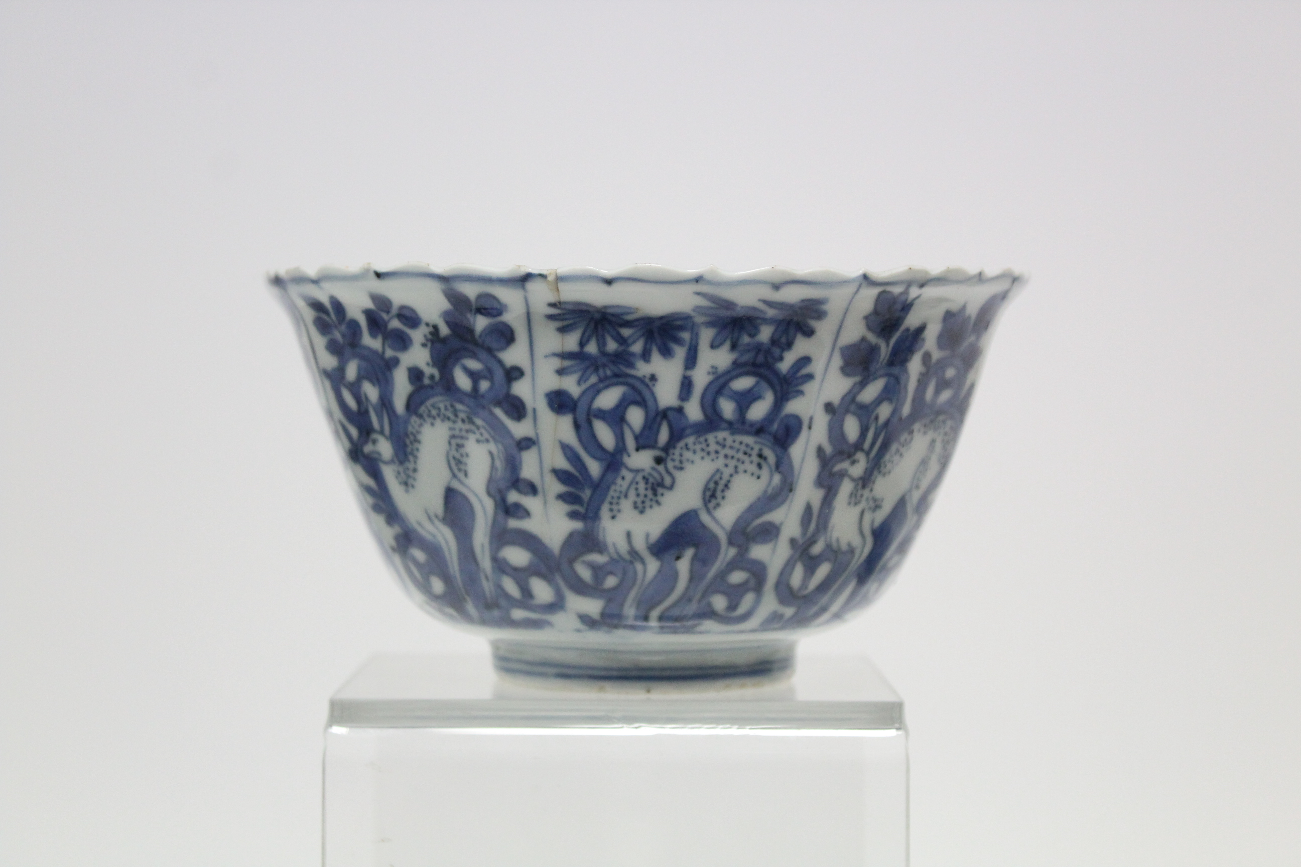 A Chinese blue & white porcelain deep bowl with lotus rim, painted with panels of deer amongst - Image 8 of 24