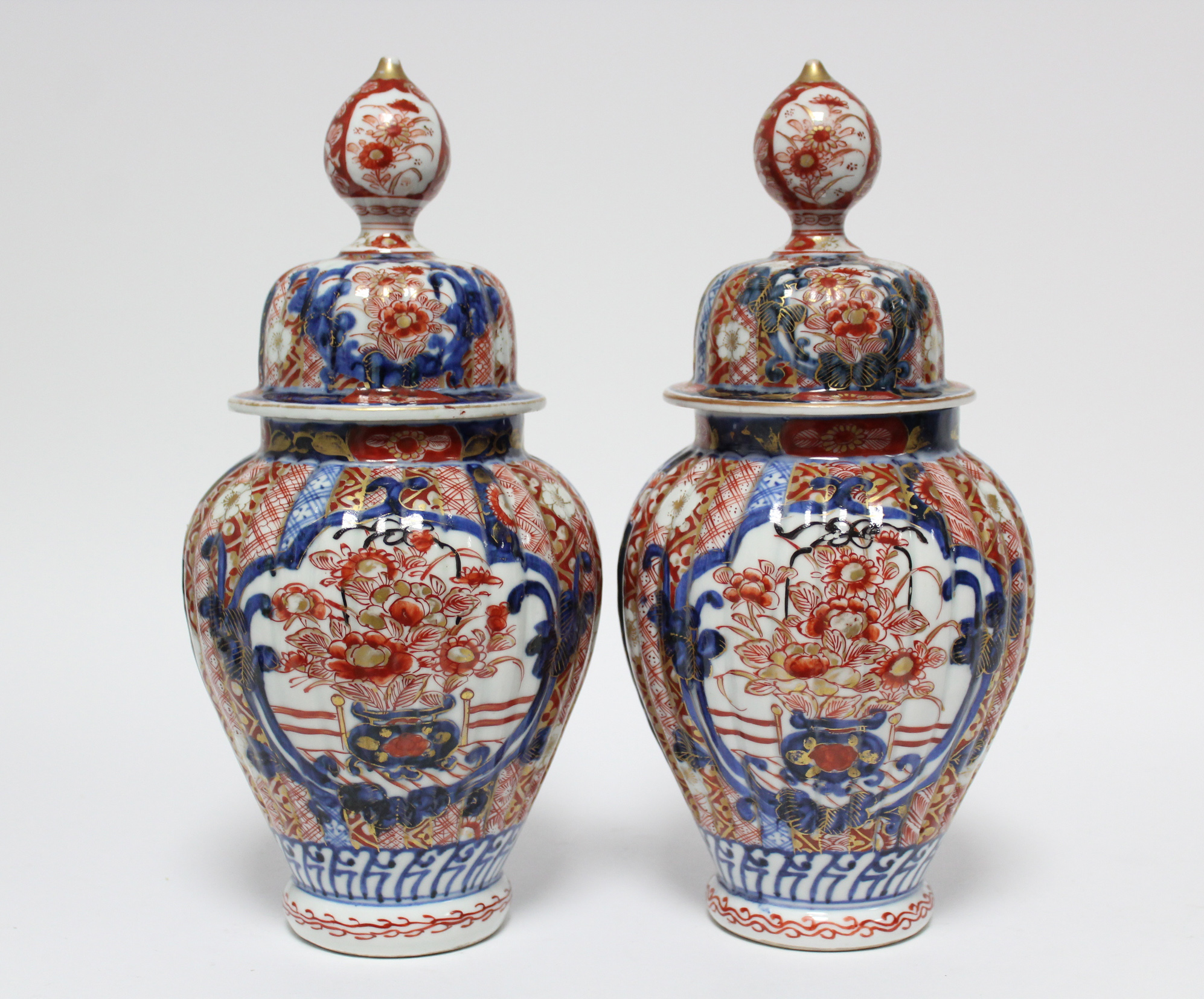 A pair of 19th century Japanese Imari fluted baluster vases with domed covers; 12” high. - Image 3 of 8