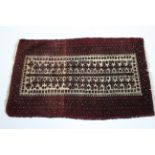 A small Persian rug of crimson & ivory ground with central design of starts & guhls within