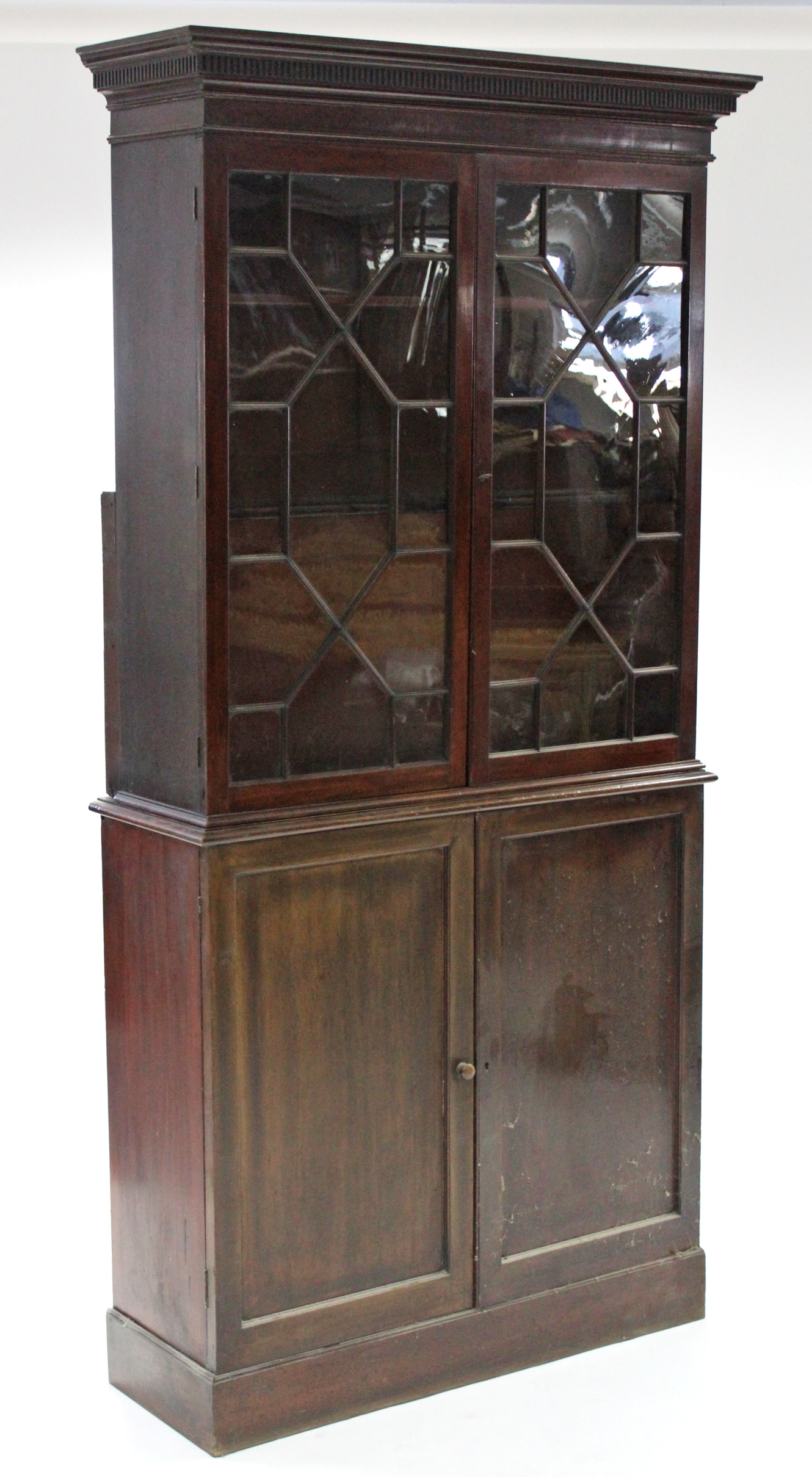 An early 19th century mahogany bookcase, with dentil cornice, fitted three adjustable shelves