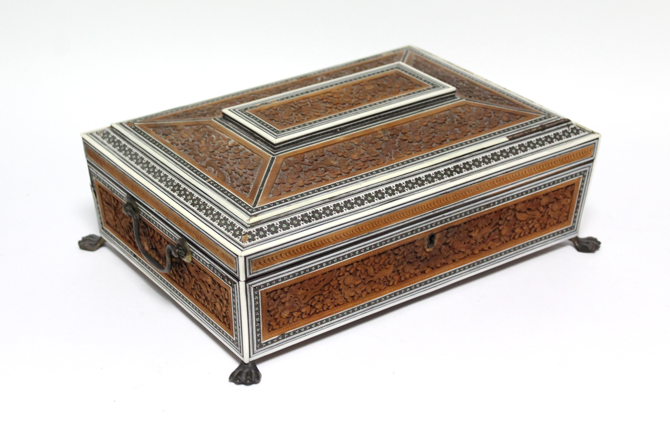 A 19th century Anglo-Indian sandalwood & ivory needlework box with hinged lid, profusely carved with