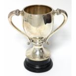 A George V large two-handled trophy cup of ovoid shape, with foliate side handles & on circular