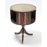 A reproduction mahogany book table inset gilt-tooled grey leather to the circular revolving top,