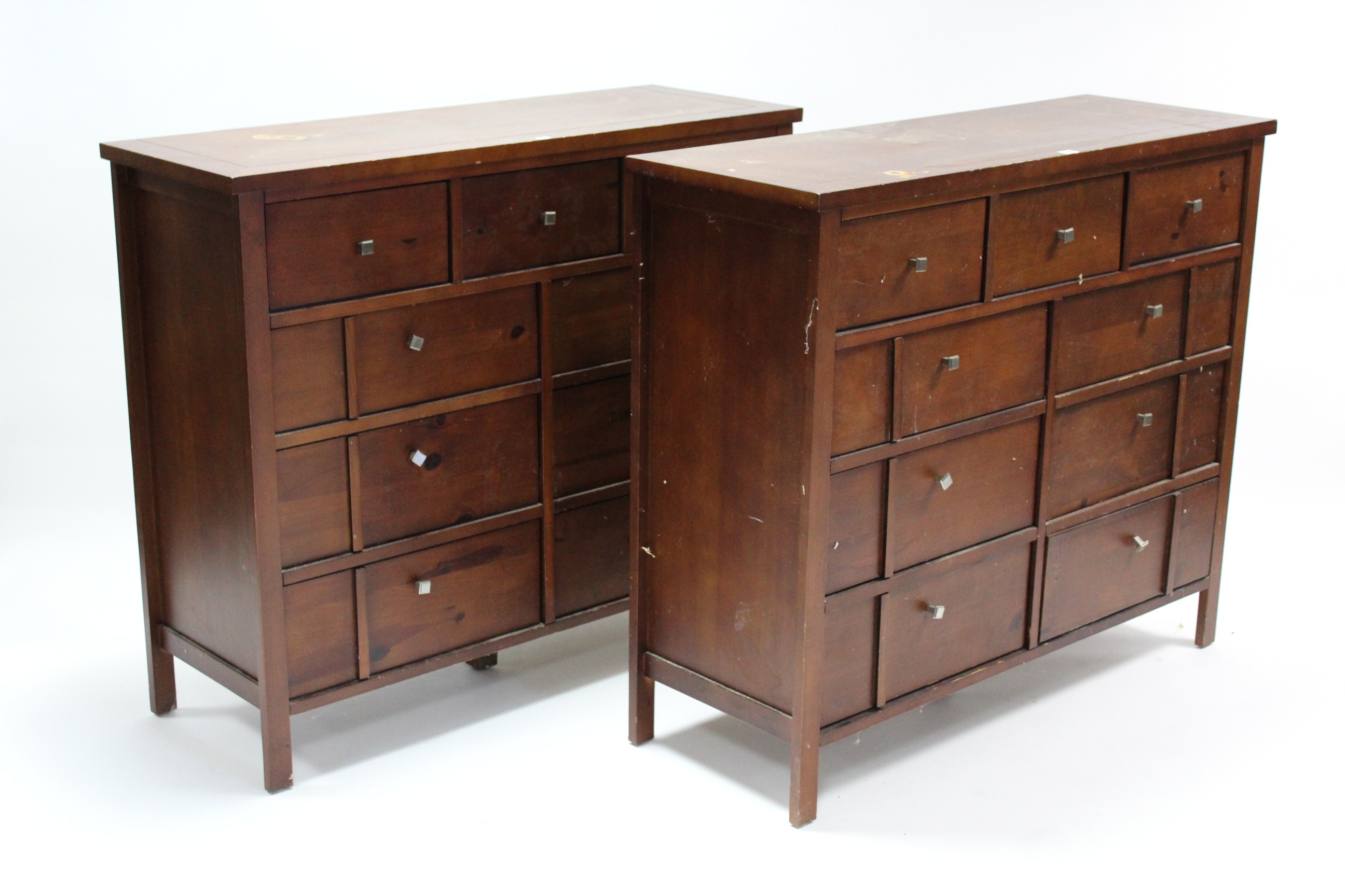 A pair of mahogany-finish chests, each fitted with an arrangement of nine drawers, 44 ¼” wide x