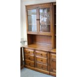 A ditto tall side cabinet with two adjustable shelves enclosed by pair of glazed doors above an open