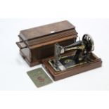 A Singer hand sewing machine with walnut case.