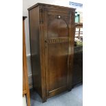 An oak narrow wardrobe enclosed by carved panel door, 31¼” wide x 71¼” high.