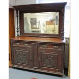 A late 19th/early 20th century carved mahogany mirror-back sideboard the upper part inset bevelled