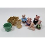 A set of five Wade Nat-West pig money banks; & three items of Sylvac pottery.