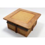 A pine large square low coffee table inset woven-cane panel & on square supports, 43” wide; & a