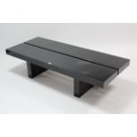 A contemporary black-finish rectangular low coffee table on square supports, 59” x 24½”.