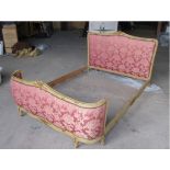 A continental-style cream painted & carved wooden frame 5’ bedstead, the head & footboard