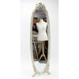 A continental-style white painted & carved wooden frame oval cheval mirror inset bevelled plate, &