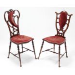 Two late Victorian mahogany occasional chairs each with pierced & shaped back, padded seat, & on