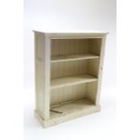 A white painted pine standing open bookcase with two open shelves, & on plinth base, 39½” wide x