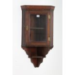 A Victorian mahogany small hanging corner cabinet fitted centre shelf enclosed by glazed door