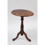 A Victorian walnut tripod table with oval top, & on spiral-twist & vase-turned centre column & three