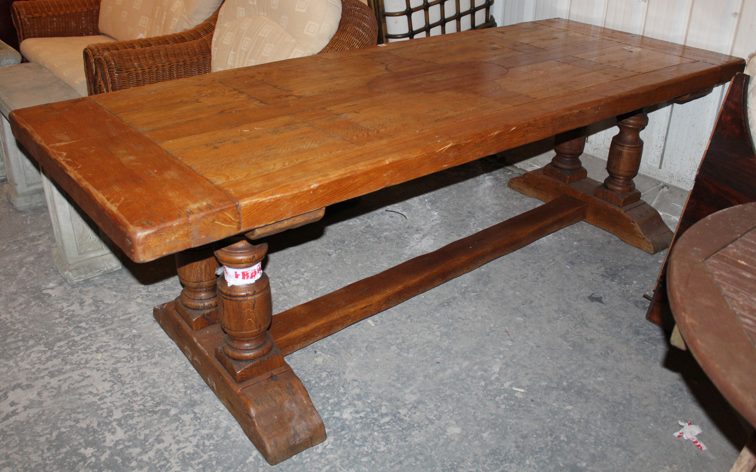 A light oak refectory table with rectangular top, & on turned end supports joined by plain centre