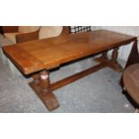 A light oak refectory table with rectangular top, & on turned end supports joined by plain centre