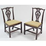 A pair of Chippendale-style carved mahogany splat-back dining chairs with padded drop-in seats &