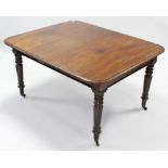 A Victorian mahogany extending dining table with rounded corners & moulded edge, on ring-turned