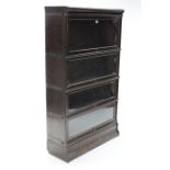 An early 20th century oak Globe Wernick four-tier sectional bookcase each tier enclosed by glazed