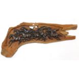 A driftwood wall panel with carved design of numerous galloping horses to centre, 66” long.