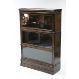 A Globe Wernicke oak three-tier sectional bookcase each tier enclosed by glazed door; & on plinth