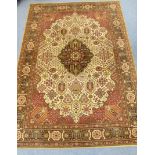 A Persian pattern carpet of ivory & crimson ground with medallion to centre & with all-over