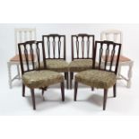 A set of four late 19th century carved mahogany rail-back dining chairs with padded seats, & on