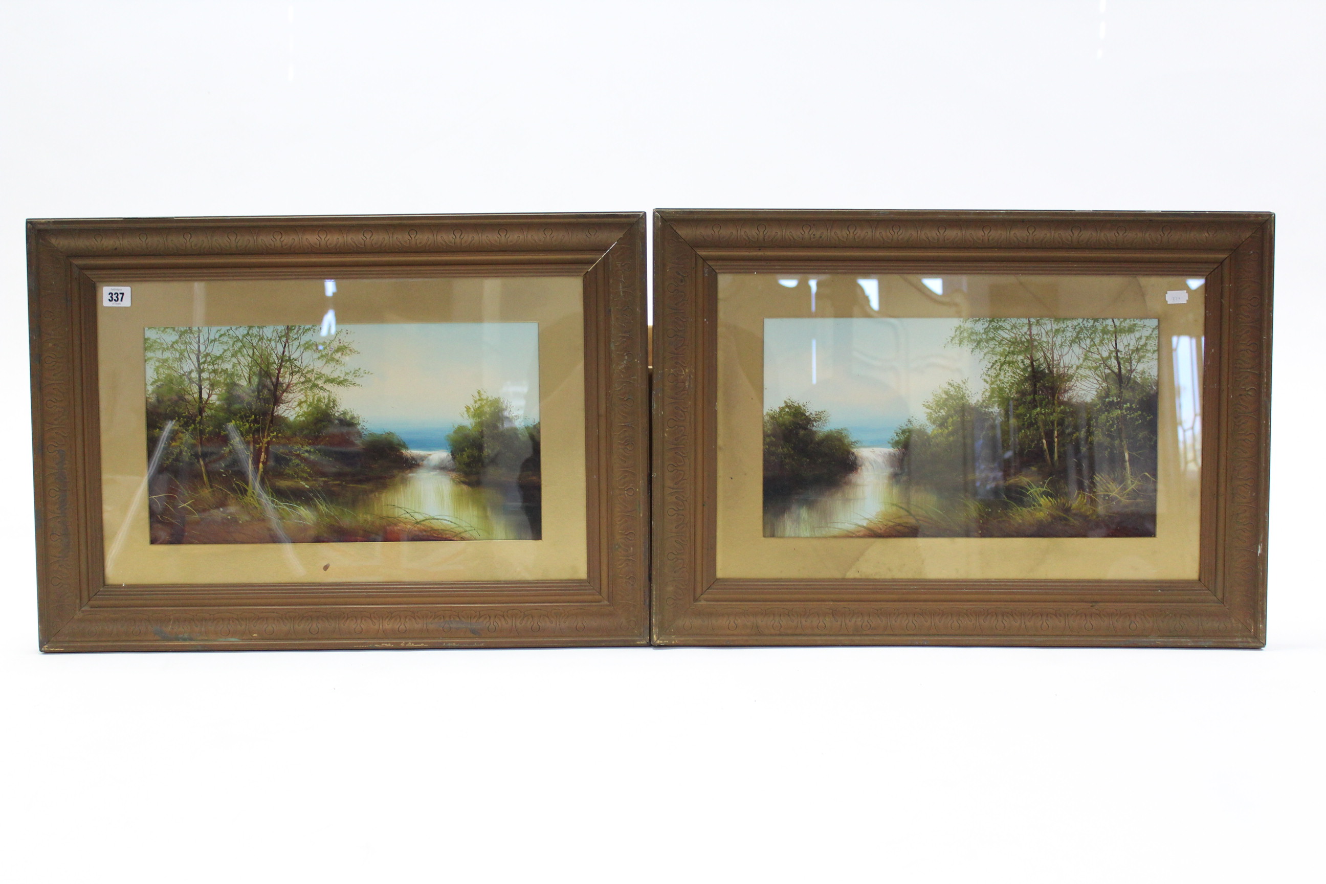 A pair of oil paintings on card, river landscapes, unsigned, 9¾” x 17½” in matching glazed gilt