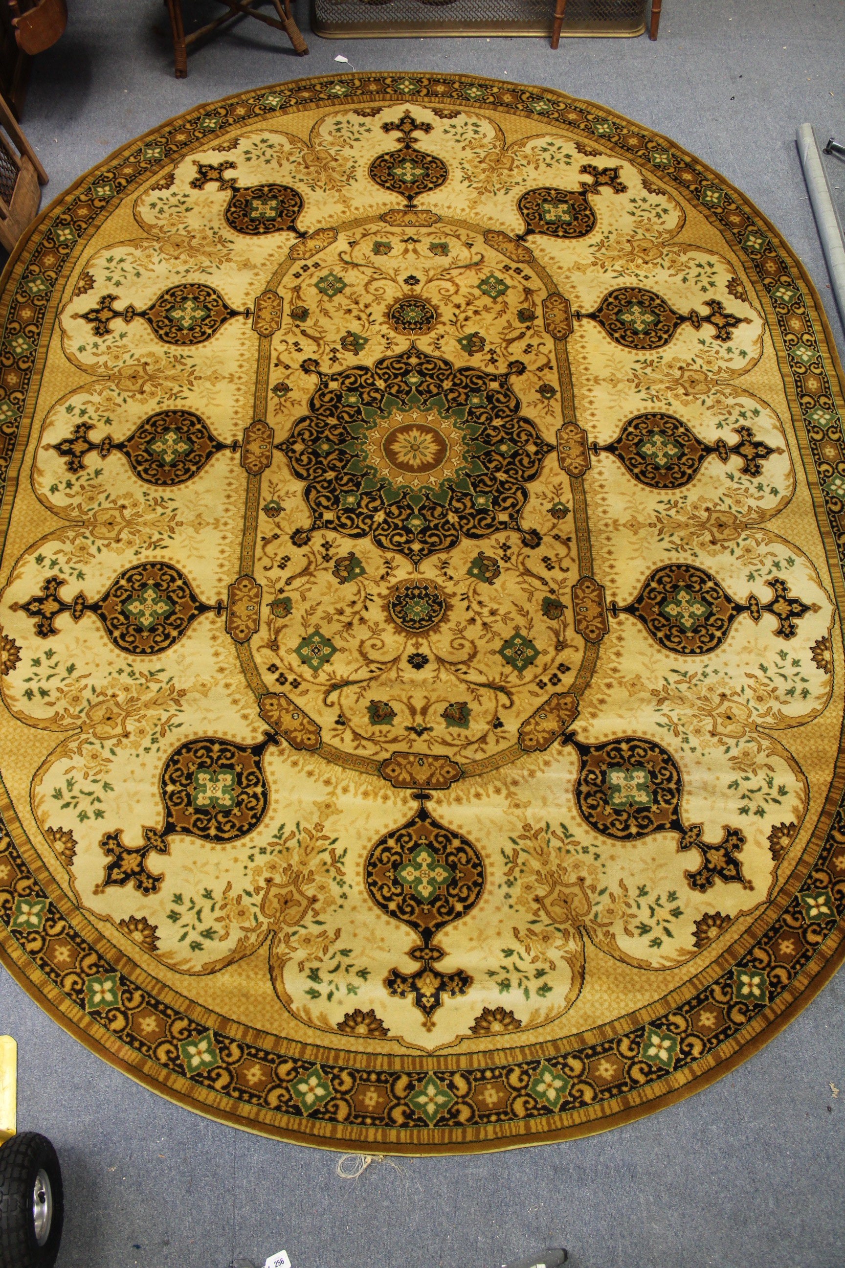 A Wilton-style oval carpet of cream & green ground with medallion to centre, & with wide border.