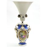 A 19th century Paris porcelain two-handled ovoid vase with painted floral panels on a blue,