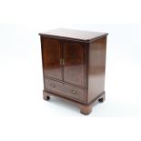 An inlaid mahogany television cabinet enclosed by pair of panel doors above a fall-front mock