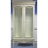 A REPRODUCTION CONTINENTAL-STYLE CREAM-FINISH WOODEN TALL CHINA DISPLAY CABINET, fitted three