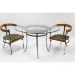 A cane & wrought-iron conservatory table on four shaped legs & with bevelled plate-glass top, 48”