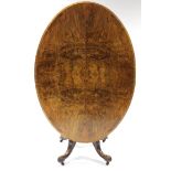 A mid-Victorian burr-walnut loo table with quarter-veneered oval top, on four slender supports