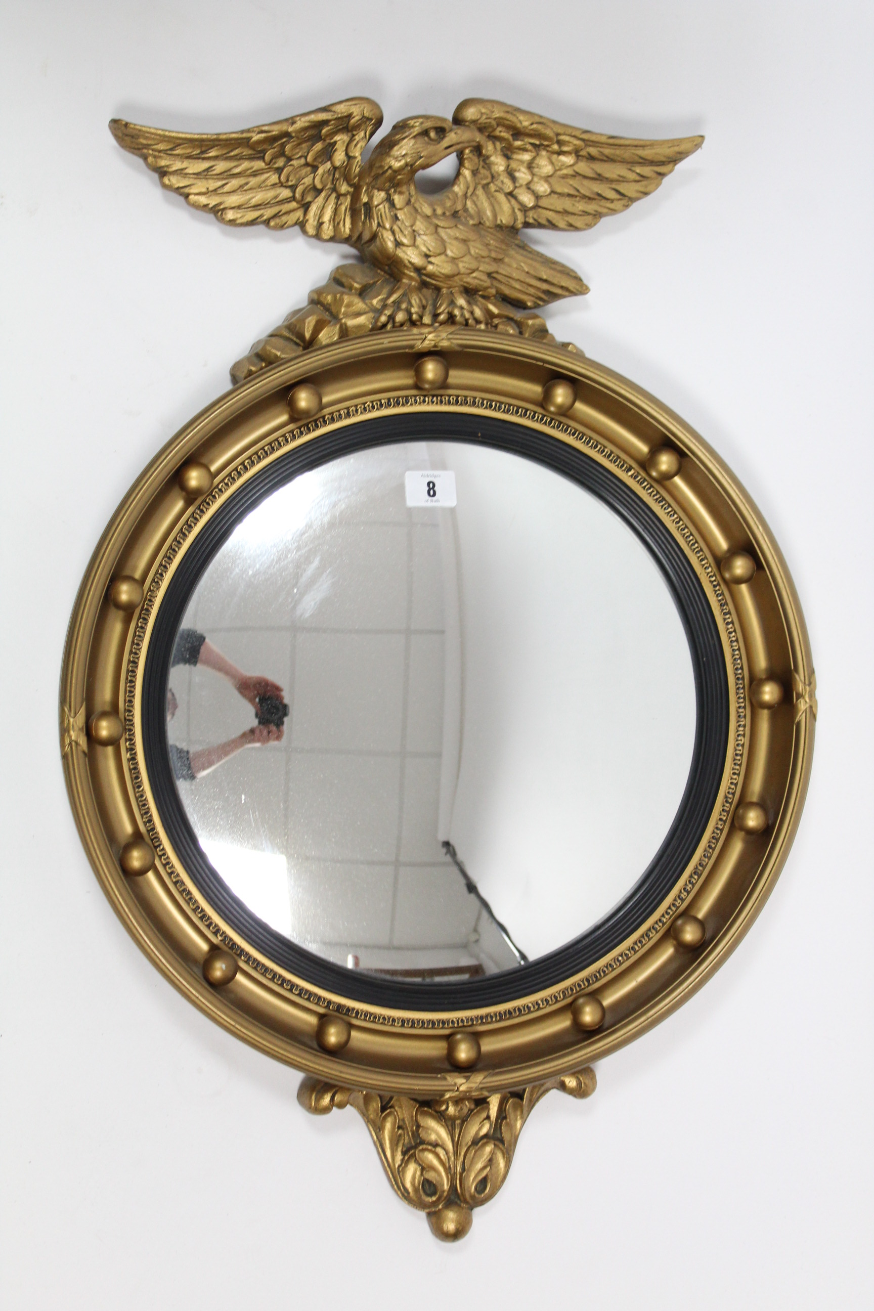 A regency-style gilt frame convex wall mirror with eagle surmount; & a cream & gold painted wooden