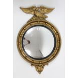 A regency-style gilt frame convex wall mirror with eagle surmount; & a cream & gold painted wooden